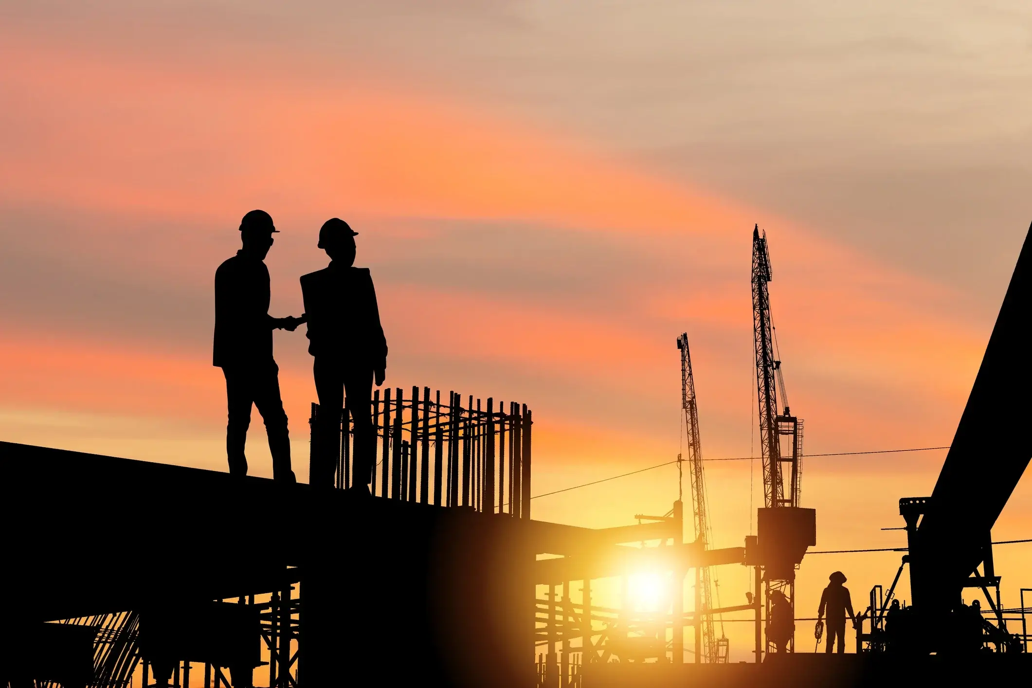 Engineering recruitment:  Engineer and worker team checking project at building site