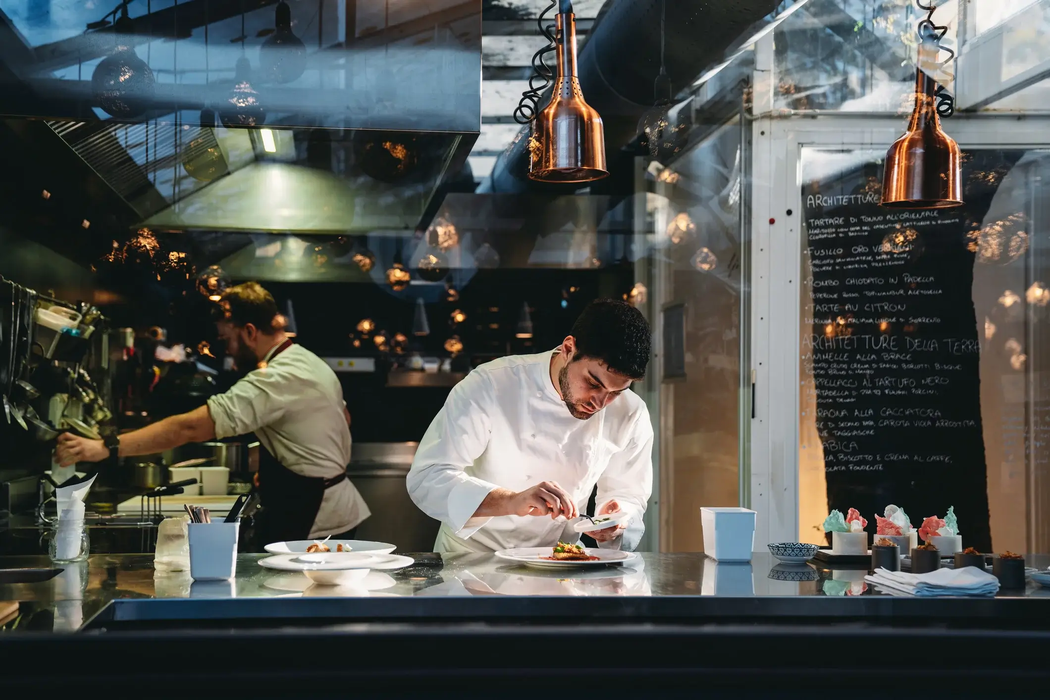 Events and Hospitality recruitment: chef preparing a meal in a kitchen.
