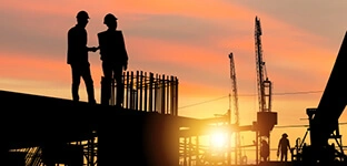 Engineering recruitment:  Engineer and worker team checking project at building site